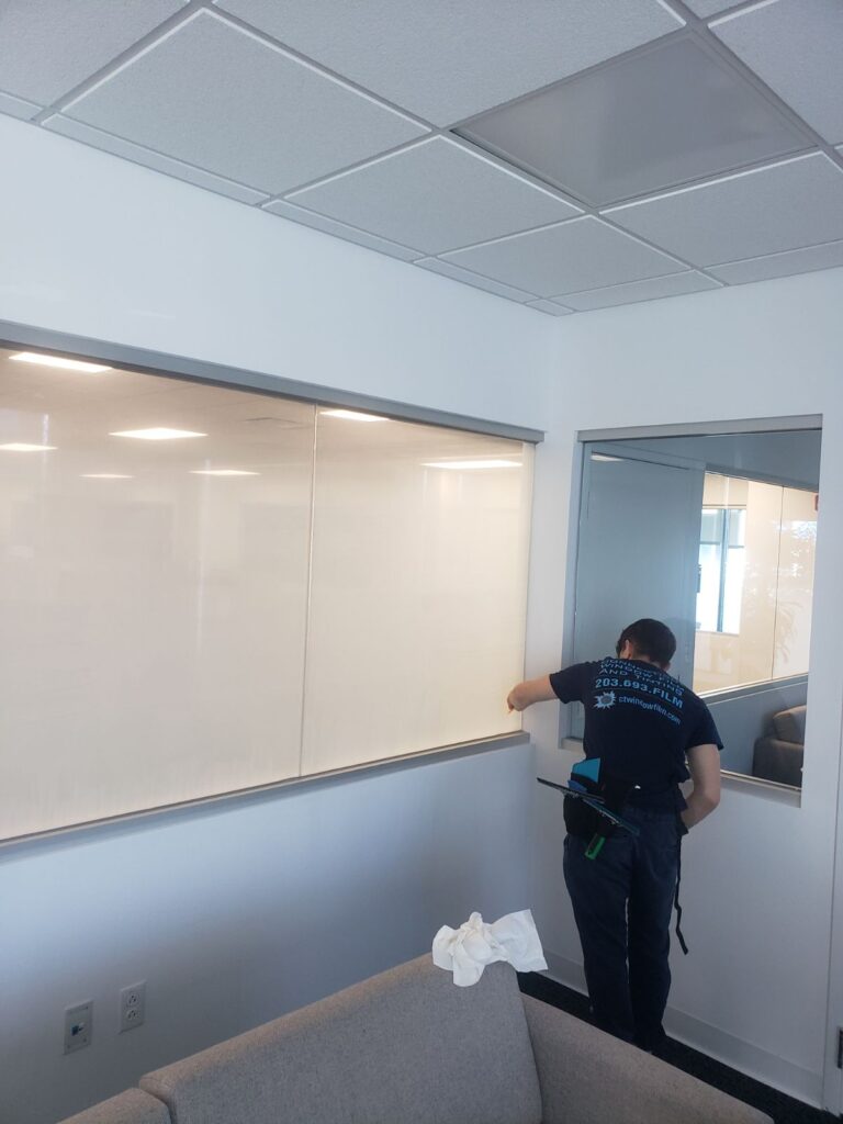 Man installing windows in office